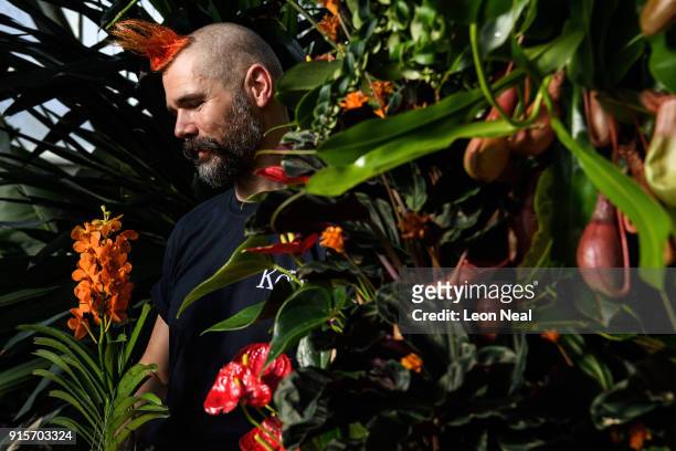 Florist Hank Roling poses with a Vanda orchid during a press preview of the Thai Orchid Festival at Kew Gardens on February 8, 2018 in London,...
