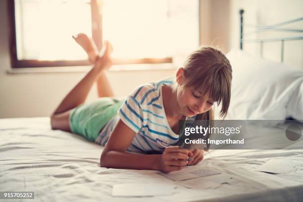 teenage girl writing vacation postcards - girls on holiday stock pictures, royalty-free photos & images