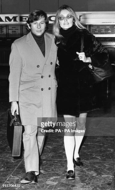 Actress Sharon Tate who stars in the film 'Valley of the Dolls', wearing tinted glasses and long white knitted socks, as she arrived at Heathrow...