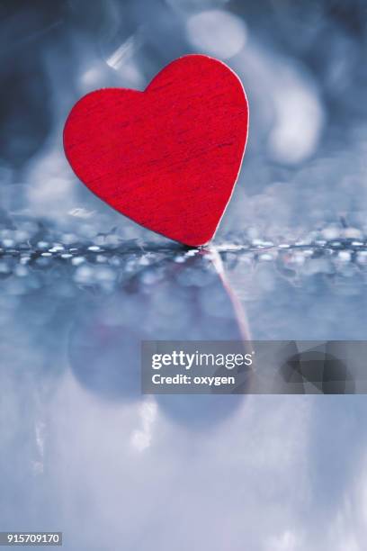 heart shape on blue bokeh background for valentines day - fahrradlampe stock-fotos und bilder