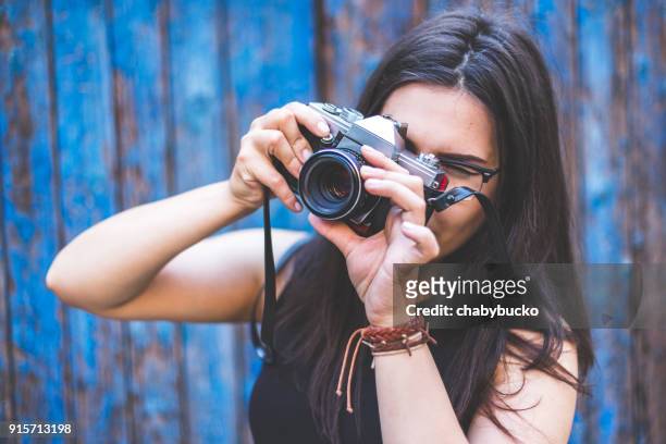 young woman taking a photo - portrait lens flare stock pictures, royalty-free photos & images