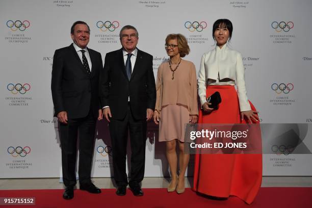 President of the International Olympic Committee Thomas Bach and his wife Claudia Bach stand with Former German Chancellor Gerhard Schröder and his...