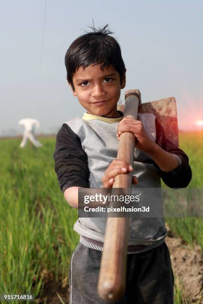 little farmer standing portrait - trabalho infantil imagens e fotografias de stock