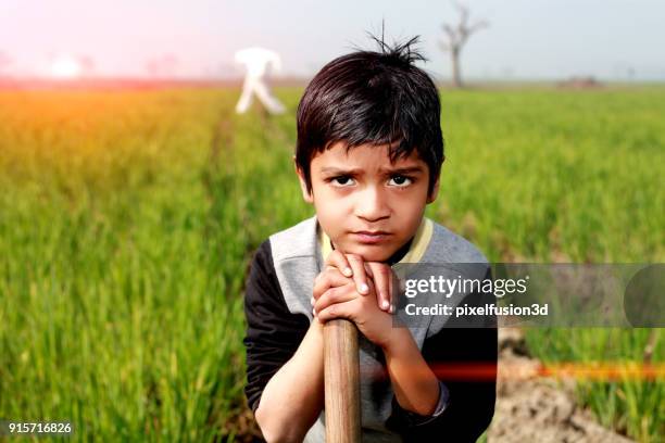 little farmer standing portrait - child labour stock pictures, royalty-free photos & images