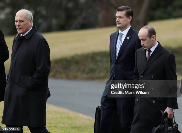 White House chief of staff John Kelly, , walks with staff secretary Rob Porter, , and White House senior advisor Stephen Miller, before boarding...