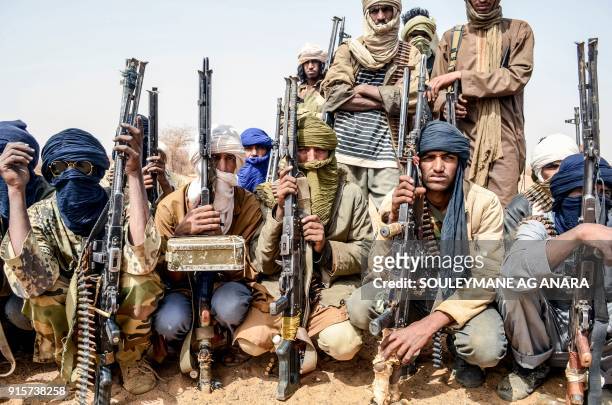 Militants of The Movement for the Salvation of Azawad listen to instructions at a waypoint while patrolling along the Mali-Niger border in the...