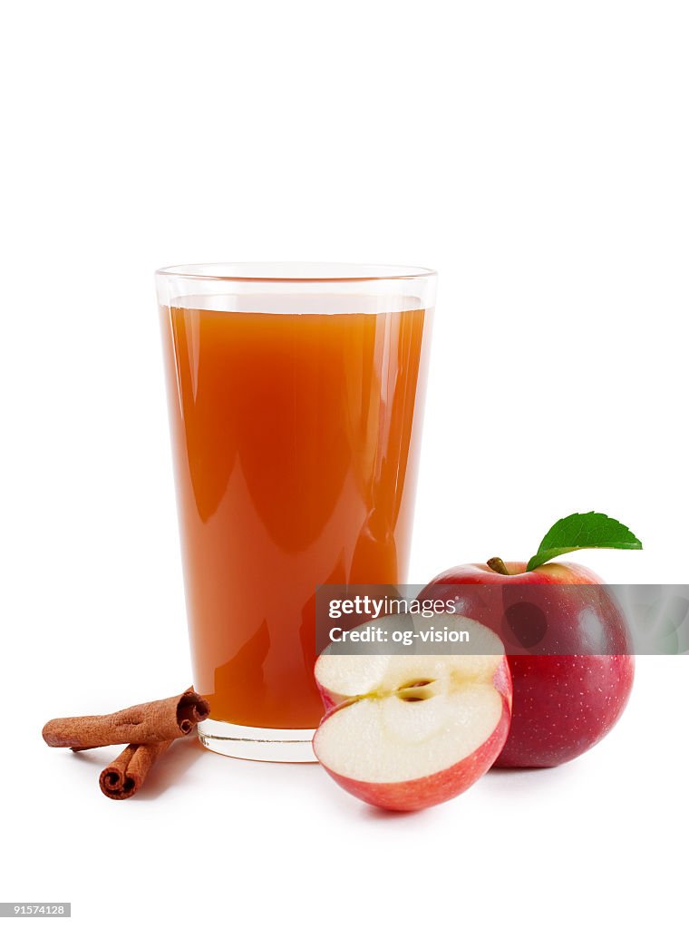 Apple cider glass decorated with fresh apples and cinnamon