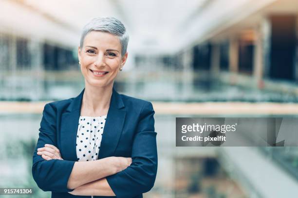 smiling middle aged businesswoman - businesswear stock pictures, royalty-free photos & images
