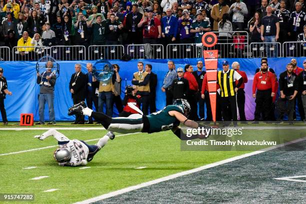 Zach Ertz of the Philadelphia Eagles dives for an 11-yard touchdown over Devin McCourty of the New England Patriots during the fourth quarter in...