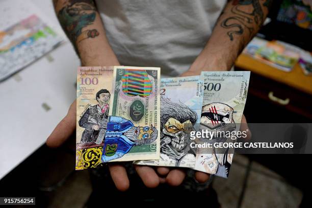 Venezuelan illustrator Jose Leon shows his artworks painted on devalued Bolivar bills, at his workshop in San Cristobal, Venezuela on February 2,...