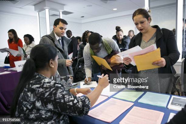 New York Department of City Administrative Services representative, left, speaks with job seekers during a Catalyst Career Group job fair in New...