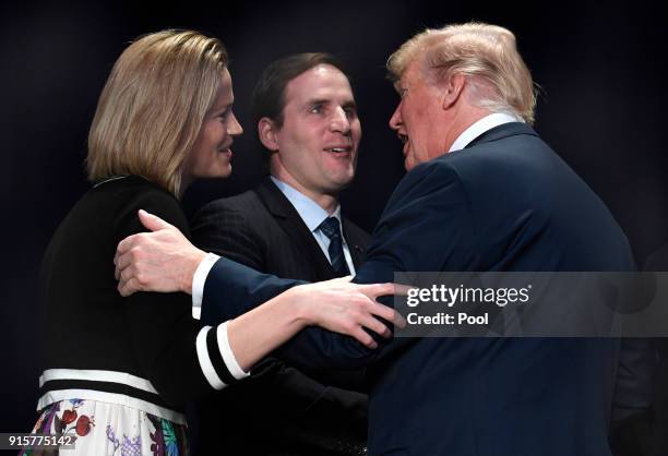 President Donald Trump greets US Army Maj. Scott Smiley , who was blinded during the Iraq War, and his wife Tiffany at the National Prayer Breakfast...