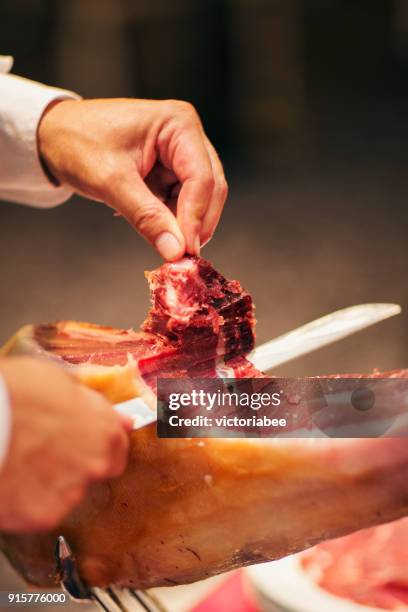 man slicing a serrano ham - smoked stock pictures, royalty-free photos & images