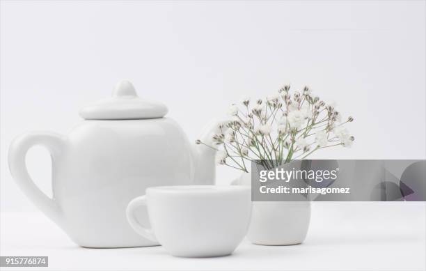 teapot, teacup and milk jug with flowers - teapot stock pictures, royalty-free photos & images