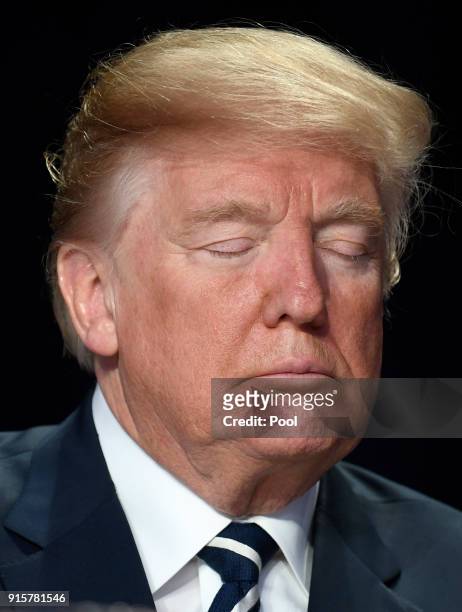 President Donald Trump closes his eyes during a moment of silence at the National Prayer Breakfast on February 8, 2018 in Washington, DC. Thousands...