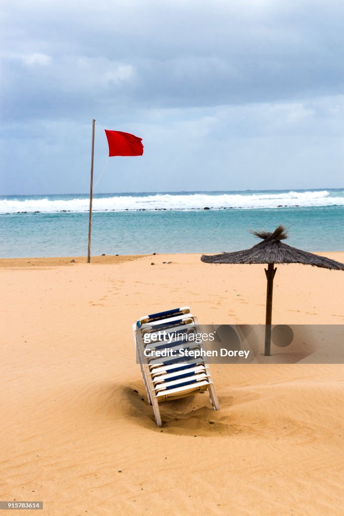 A red flag flying on the beach on the Canary Island of Fuerteventura