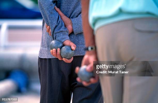 men holding petanque boules in nice - boule stock pictures, royalty-free photos & images