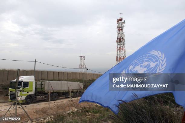 Picture taken on February 8 from Lebanon's southern border town of Naqura, shows an Israeli lorry transporting blocs of cement to build sections of a...