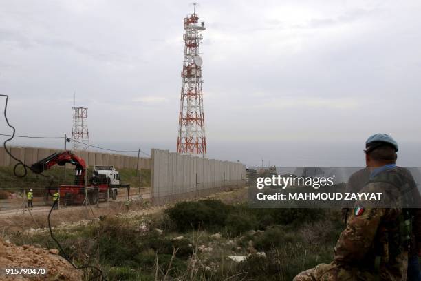 Picture taken on February 8 shows a UN peacekeeping force in Lebanon liaison watching from Lebanon's southern border town of Naqura, as an Israeli...