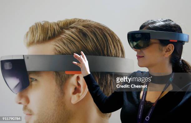 Visitor tries a virtual reality headset Microsoft HoloLens during the 'Virtuality Paris 2018' show on February 08, 2018 in Paris, France. Microsoft...