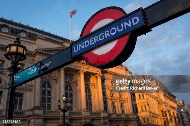 Winter sunshine on a London Underground sign and the Trocadero in Piccadilly Circus, on 6th February 2018, in London, England.