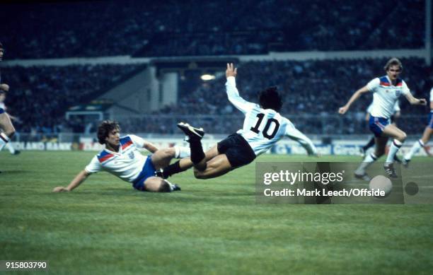 International Football Friendly Match England v Argentina : Diego Maradona runs with the ball into the England penalty area where he is tackled by...