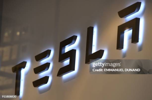 This photo shows the logo if US car maker Tesla in Brussels on February 8, 2018 - A day after launching one of its cars into space, Tesla moved on...