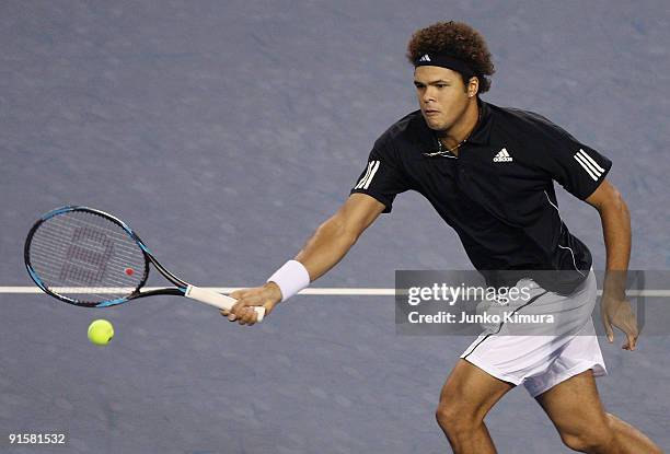 Jo-Wilfried Tsonga of France plays a forehand in his match against Richard Gasquet of France during day four of the Rakuten Open Tennis tournament at...