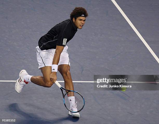 Jo-Wilfried Tsonga of France plays a backhand in his match against Richard Gasquet of France during day four of the Rakuten Open Tennis tournament at...