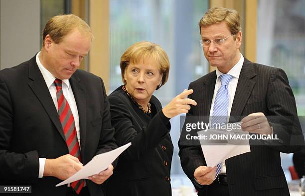 Dirk Niebel , the general-secretary of Germany's Free Democratic Party , FDP Chairman Guido Westerwelle and German Chancellor Angela Merkel of the...