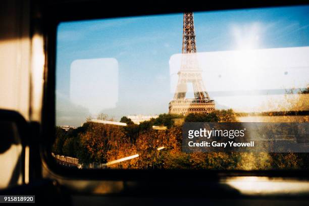 eiffel tower seen from a train window - paris france stockfoto's en -beelden