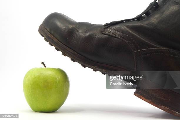 old military shoes and green apple - stamping feet stock pictures, royalty-free photos & images