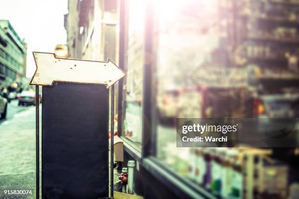 blank blackboard and arrow sign on the street - shop sign stock pictures, royalty-free photos & images