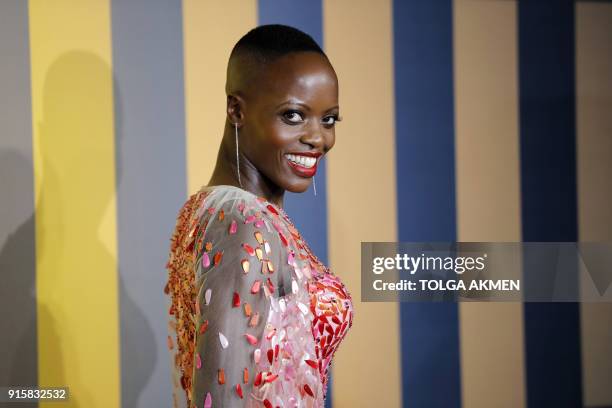 Ugandan-born German actress Florence Kasumba poses on arrival for the European Premiere of 'Black Panther' in central London on February 8, 2018. /...