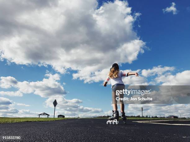 little girl inline skating at park - amusement park ohio stock-fotos und bilder