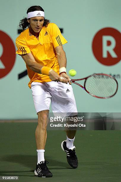 Juan Monaco of Argentina returns a shot in his match against Ernests Gulbis of Latvia during day four of the Rakuten Open Tennis tournament at Ariake...