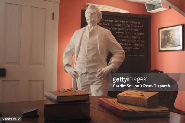 Likeness of Mark Twain stands in the Samuel Clemens boyhood home in Hannibal, Mo.