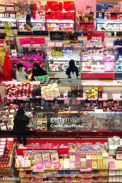 Japanese women look at chocolates displayed at a department store ahead of Valentine's Day in Tokyo February 8, 2018.