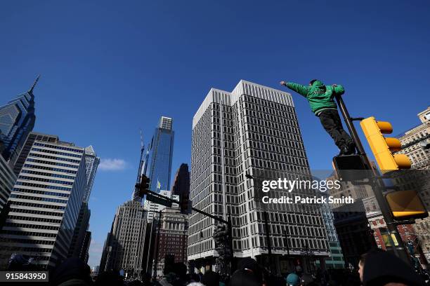 Fans celebrate with the Philadelphia Eagles during their NFL Super Bowl victory parade on February 8, 2018 in Philadelphia, Pennsylvania. The...