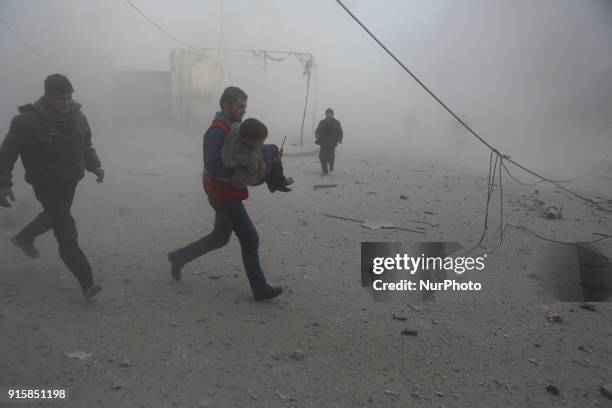 Syrian Arab Red Crescent attempt to rescue the wounded after the bombing of the city of Douma with missiles from the Syrian regime aircraft in...
