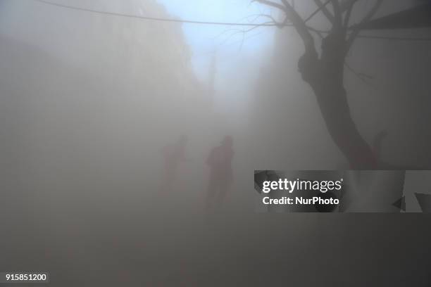 Syrian Arab Red Crescent attempt to rescue the wounded after the bombing of the city of Douma with missiles from the Syrian regime aircraft in...