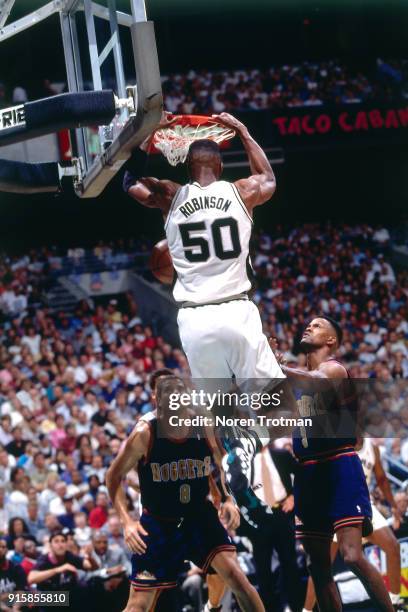 David Robinson of the San Antonio Spurs dunks during Game One of the First Round of the 1995 NBA Playoffs played on April 28, 1995 at the Alamo Dome...