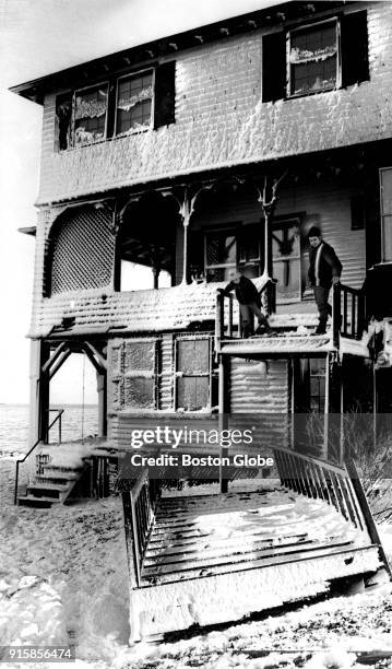 James Michaud, and his son Jimmy examine the damage to their home on Bay View Avenue in Salem, Mass., on Feb. 8 following the Blizzard of 78.