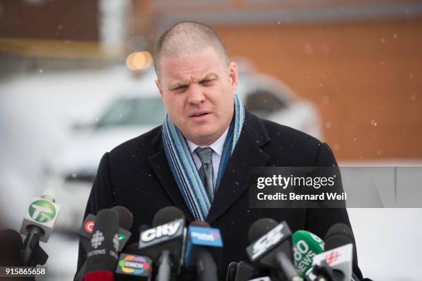 Officer Hank Idsinga speaks to the media where investigators removed evidence from inside the home at 53 Mallory Cresc., Toronto. Planters containing...