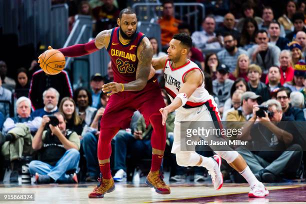 LeBron James of the Cleveland Cavaliers tries to drive around Evan Turner of the Portland Trail Blazers during the second half at Quicken Loans Arena...