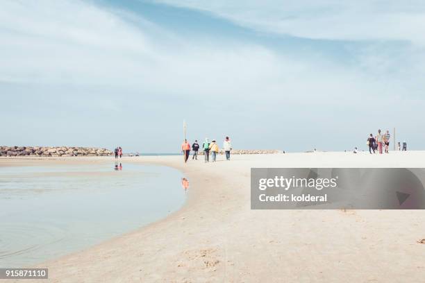 people vacationing and sunbathing on mediterranean beach - herzliya marina bildbanksfoton och bilder