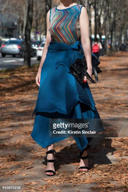 Brazilian style consultant Tay Borges wears an Issey Miyake top, skirt and bag and Luiza Barcelos Loja shoes day 4 of Paris Womens Fashion Week...