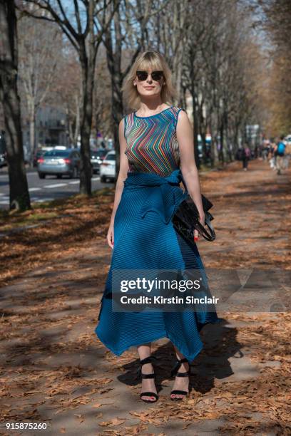 Brazilian style consultant Tay Borges wears an Issey Miyake top, skirt and bag, Super by Retro super future sunglasses and Luiza Barcelos Loja shoes...