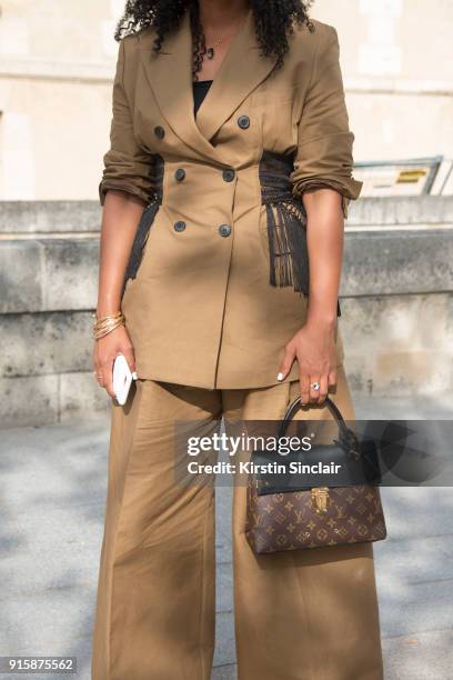 Fashion stylist and consultant Shiona Turini wears a Dries Van Noten suit, Louis Vuitton bag, Givenchy sunglasses and Dior shoes day 4 of Paris...