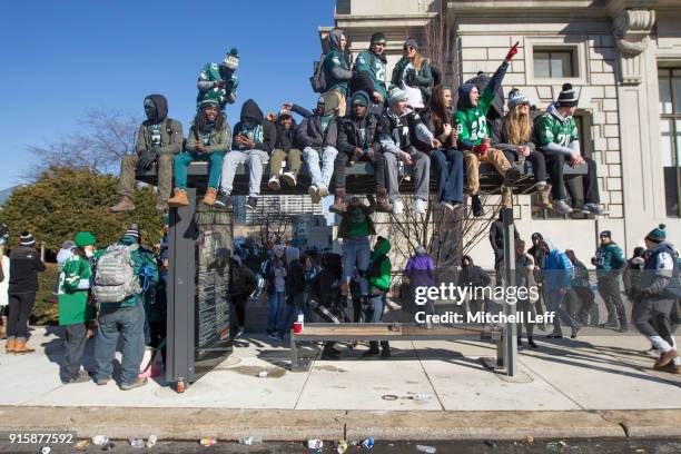Philadelphia Eagles fans watch the Super Bowl LII parade from a bus stop waiting area on February 8, 2018 in Philadelphia, Pennsylvania.